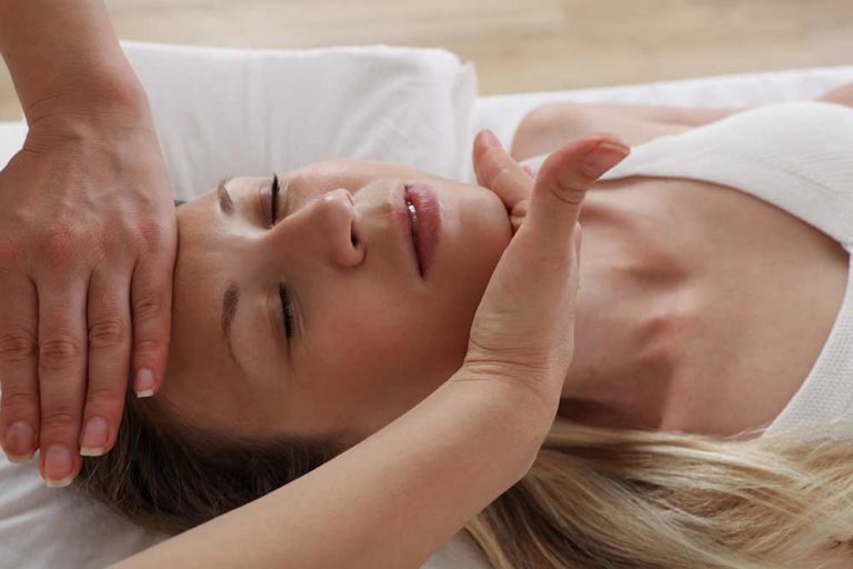 Reiki healing, massage, woman being treated.